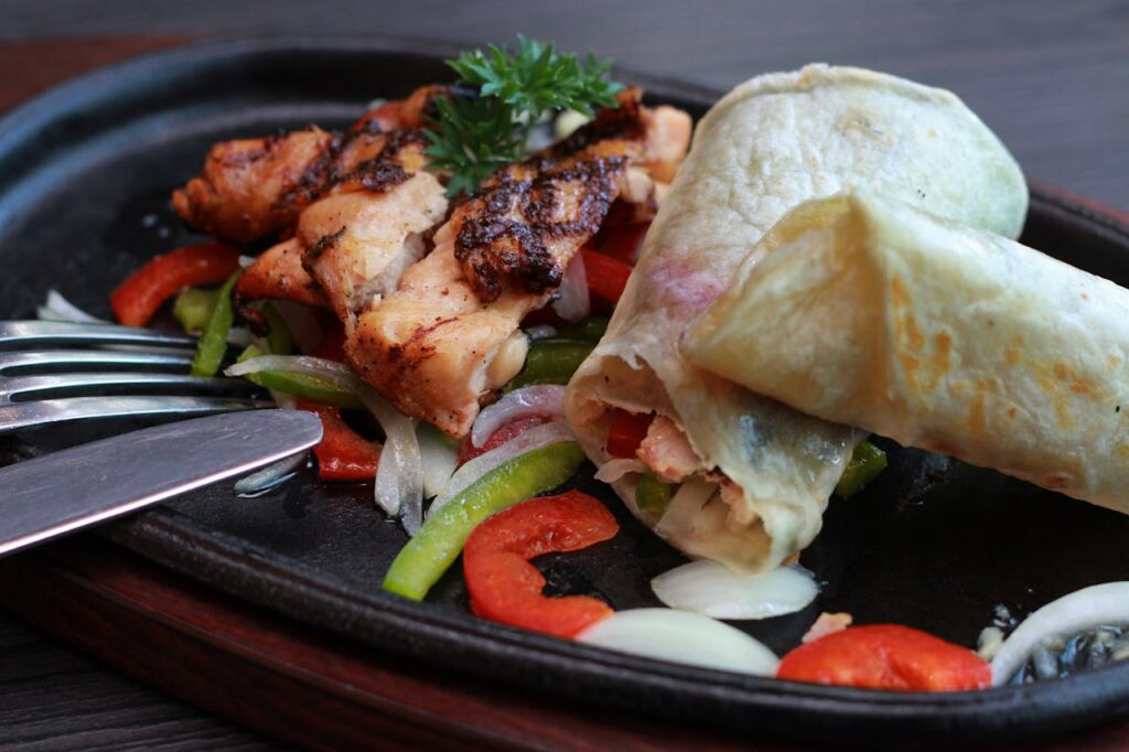 Meats and Vegetables on Black Oval Sizzling Plate